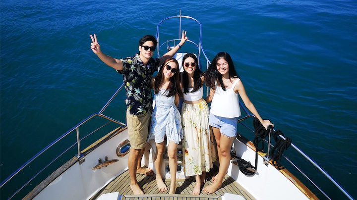 Friends enjoying their graduation party on luxury yachts